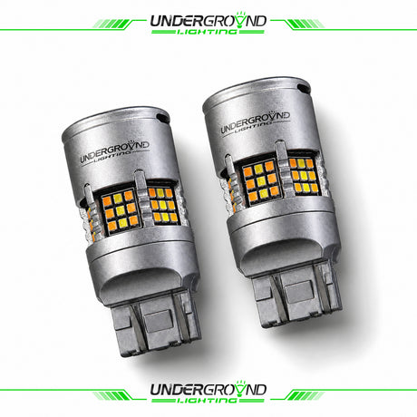 Two Underground Lighting car bulbs on a white background with brand logo.