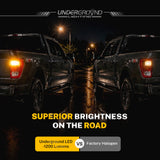 Two ford trucks on a road at night with 'Underground Lighting' branding, highlighting superior brightness of 2021–2023 Ford F-150 STX LED Rear Turn Signal Replacement Bulbs for 3X Rear Visibility| 4257 Amber bulbs