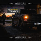 Ford F150 truck with glowing 2021–2023 Ford F-150 STX LED Rear Turn Signal Replacement Bulbs for 3X Rear Visibility| 4257 Amber taillight at sunset, featuring Underground Lighting branding.